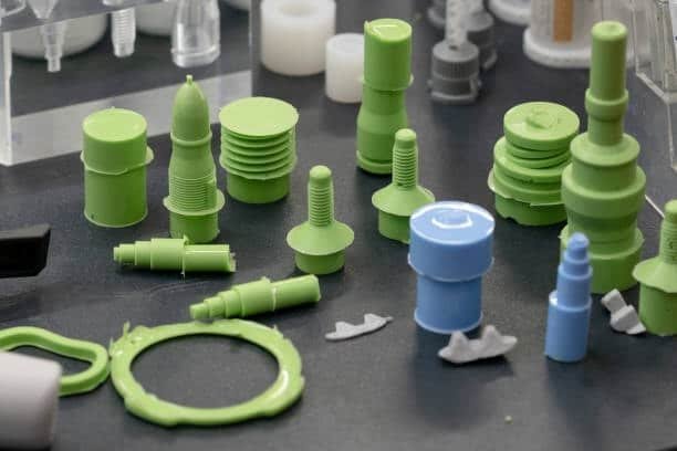 Collection of injection molded plastic parts showing different finishes and surface treatments