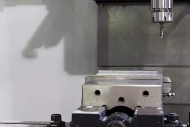 CNC vertical milling machine with fixture and clamped metal block