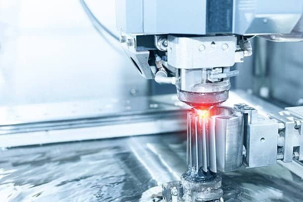 Wire EDM machine cutting gear teeth with precision and laser alignment