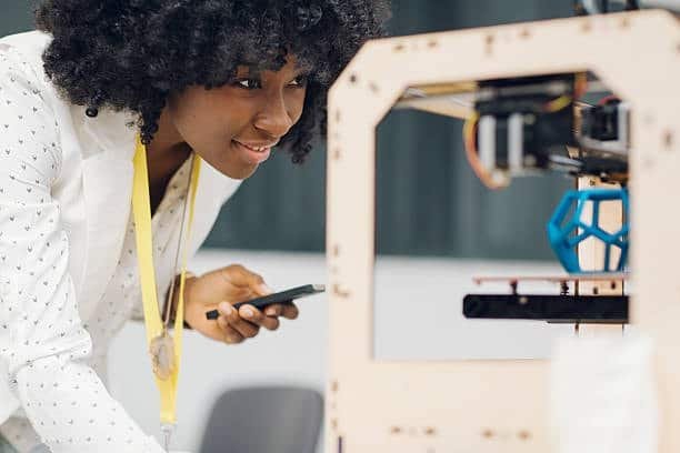 Woman inspecting a 3D printed dodecahedron object