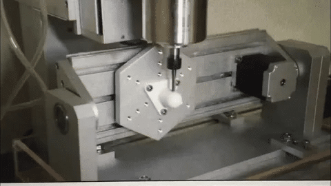 CNC milling machine with rotary table demonstrating 4th axis motion.