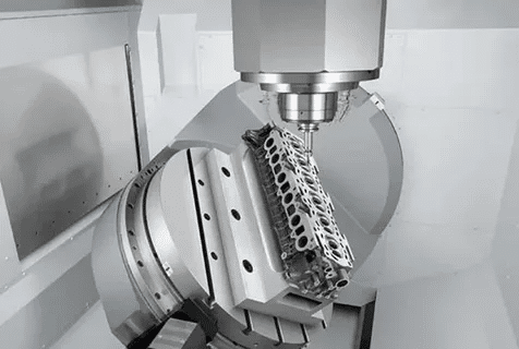 5-axis CNC machine tilting workpiece for engine block surfacing operations.