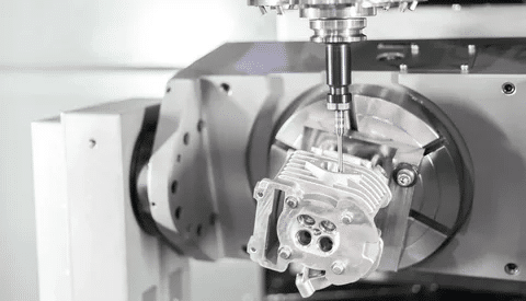 5-axis CNC machine processing complex aluminum geometry with dynamic rotation.