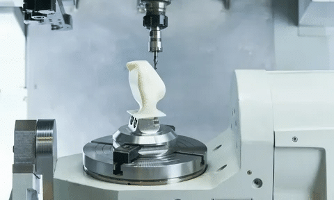 5-axis CNC machine milling a plastic model for medical testing