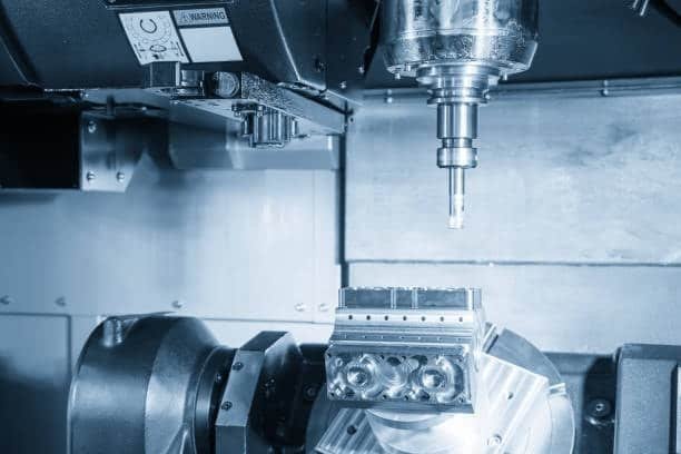 5-axis CNC machine in action, performing multi-angle cutting on an intricate component