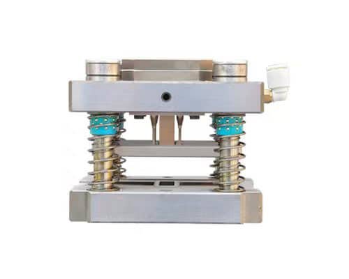 Spring-loaded precision stamping die with steel frame and coil springs on a white background.
