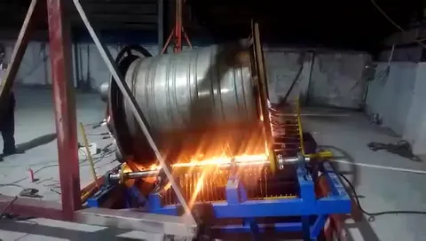 Rotational molding heating stage with mold exposed to high heat for polymer melting and coating.