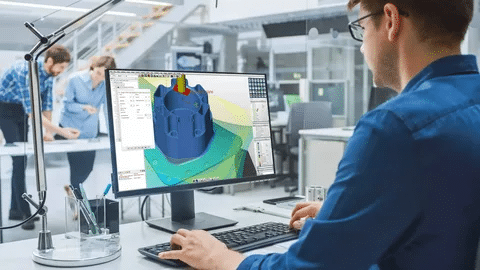 Operator designing a component in CAM software for CNC machine programming