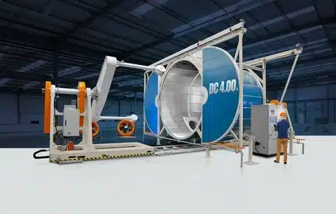 Industrial rotational molding machine with biaxial drum rotation for producing large hollow plastic parts.