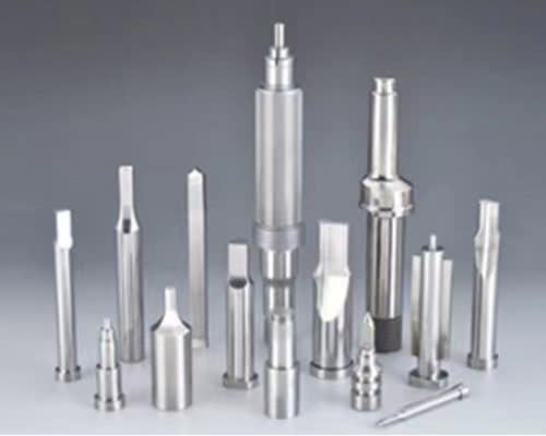 Various core pins and guide posts for injection molding, displayed upright with polished metal finishes and differing diameters.