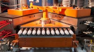Industrial injection molding machine forming multiple plastic caps simultaneously in high-volume production