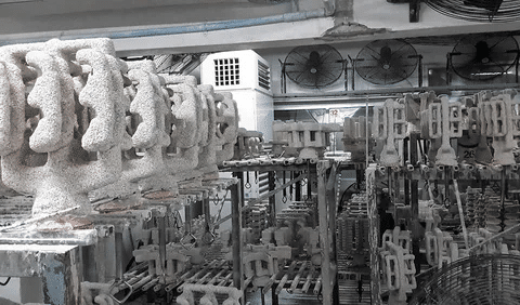 Investment casting shells arranged in a foundry before molten metal pouring.