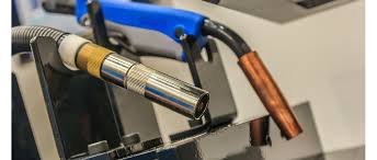 Close-up of MIG welding torch with copper tip and TIG welding torch with gas nozzle side by side