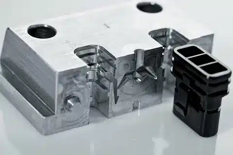 Precision-machined aluminum rapid injection mold with black plastic connector part