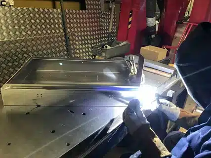 Precision TIG welding on a stainless steel sheet metal enclosure