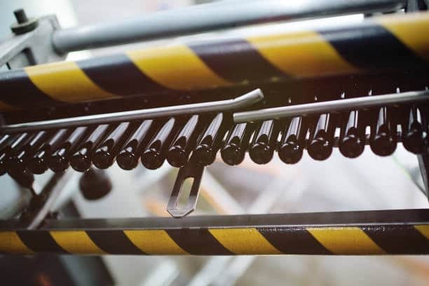 Production line showing plastic preforms aligned for injection or blow molding