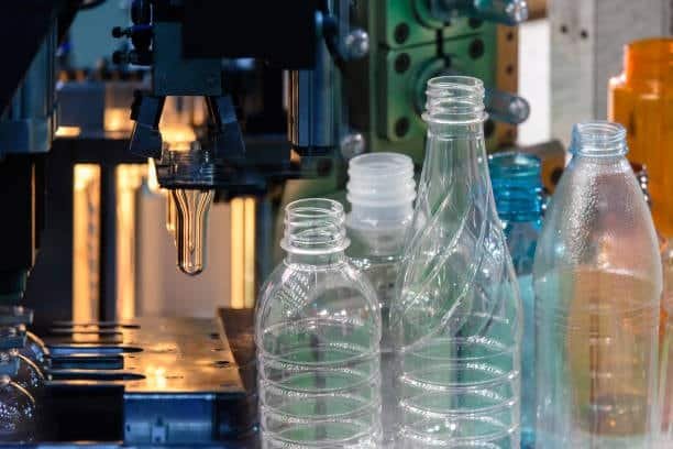 Blow molding machine forming PET bottles from heated preforms