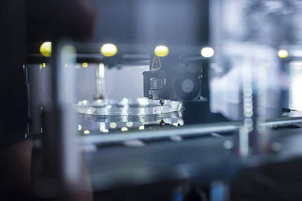 Transparent plastic component being 3D printed inside an enclosed machine