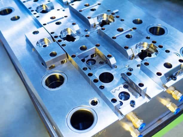 Close-up view of a complex metal injection mold base
