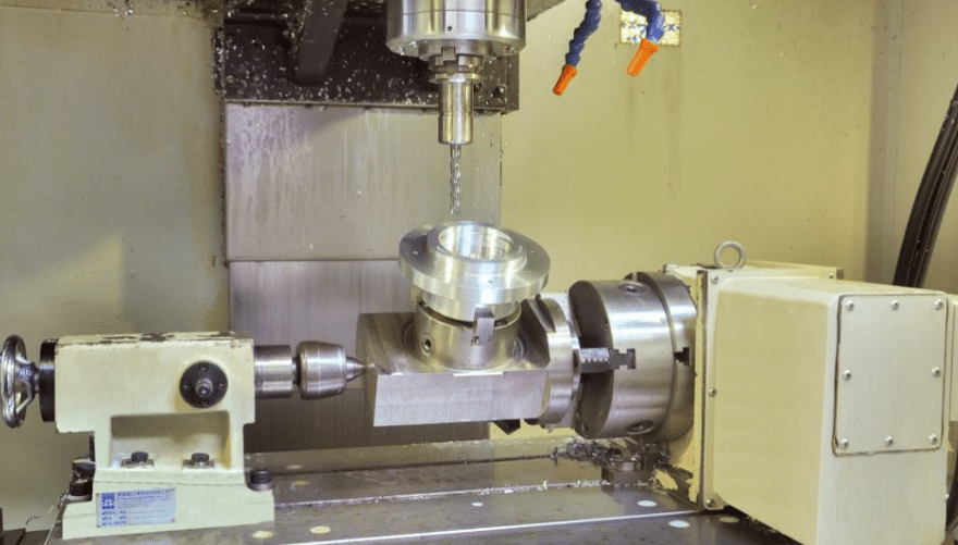 A CNC 4-axis machine using a rotary table for enhanced part accessibility.