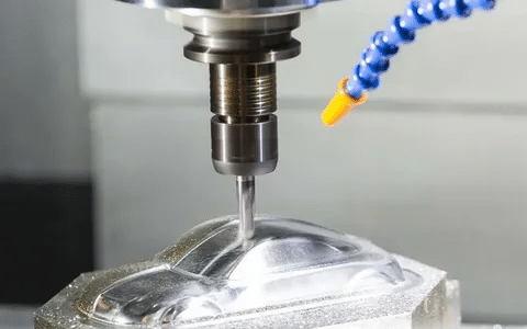 CNC machine cutting aluminum block into car mold part.