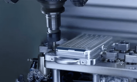 CNC machine processing aluminum smartphone housing in a precision fixture