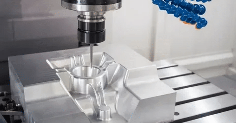 CNC milling machine cutting a complex mold cavity into aluminum block