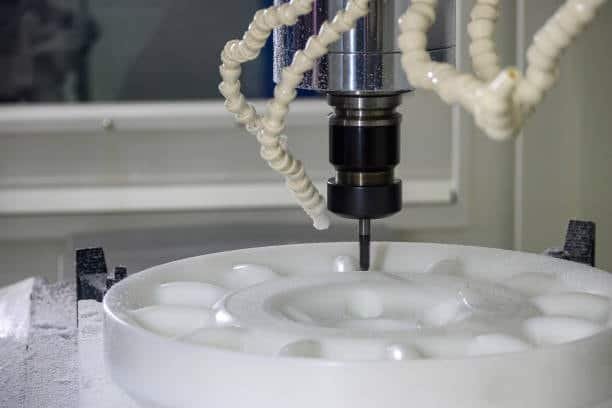 CNC machine milling a large circular plastic disk