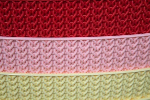 Patterned plastic surfaces demonstrating knit line simulation in different colors