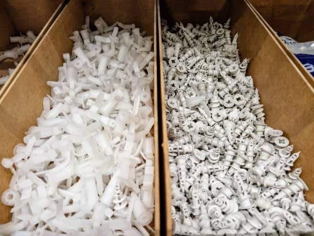 Delrin and nylon molded parts stored in cardboard boxes