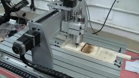 Desktop CNC router machine carving wood panel