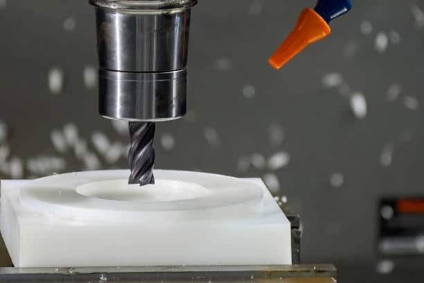 CNC end mill cutting into a solid plastic block