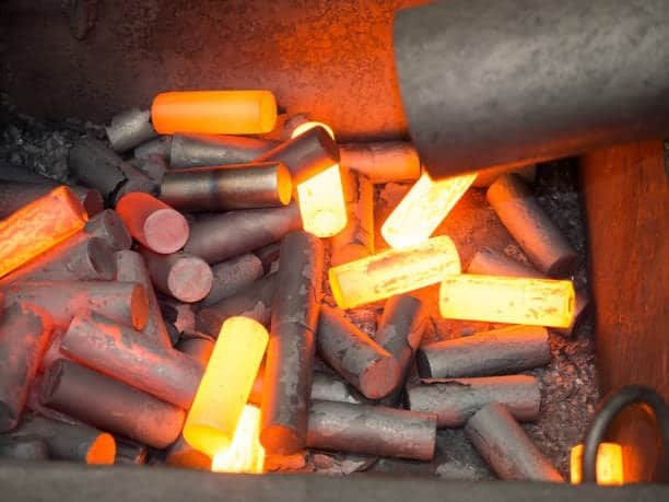 Red-hot cylindrical steel billets ready for hot forging process