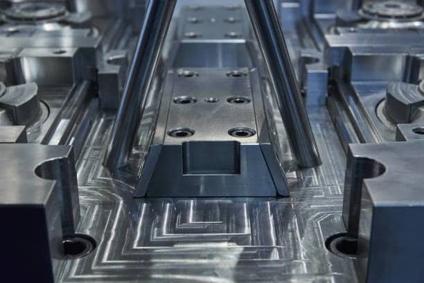 Central core block and steel inserts in high-precision injection mold tooling