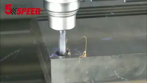 High-speed end mill cutting through steel with sparks during MRR optimization