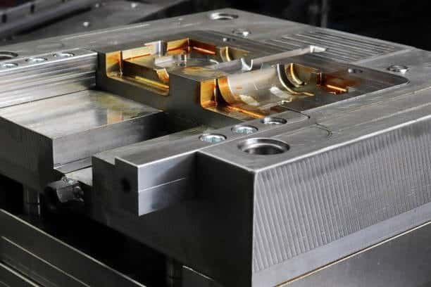 Close-up of injection mold cavity highlighting surface finish and possible defect zones
