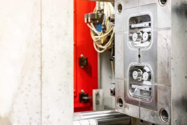 Injection mold cavity prepared for insert molding with space for pre-placed components