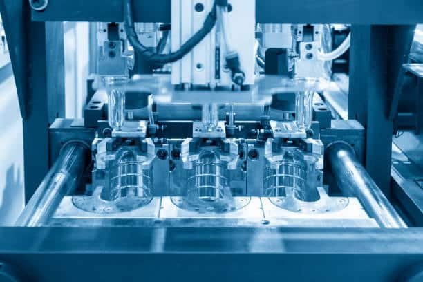 Injection molding machine with dual cavities for mass plastic part production