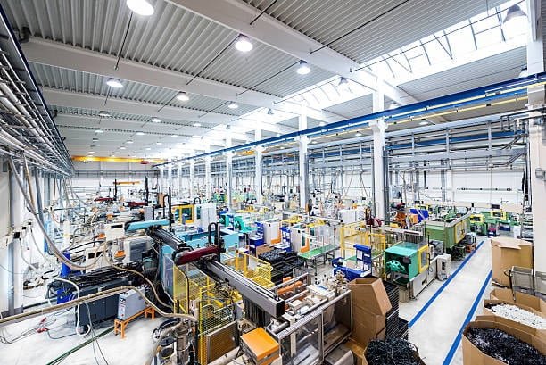 Wide view of an injection molding manufacturing factory with multiple machines