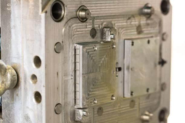 Injection mold cavity featuring stepped core geometry and draft angles