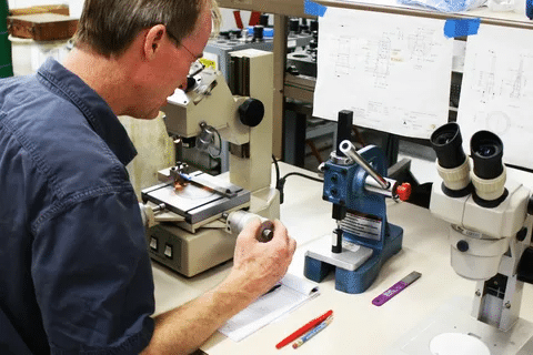 Mold tolerance inspection using microscope and precision tools.