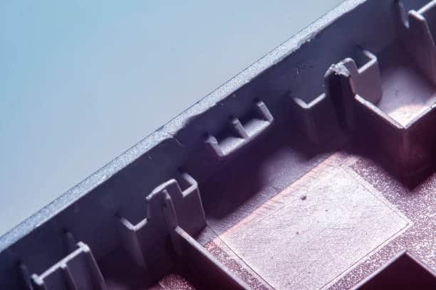 Close-up of overmolded part showing texture transition between base and outer layer
