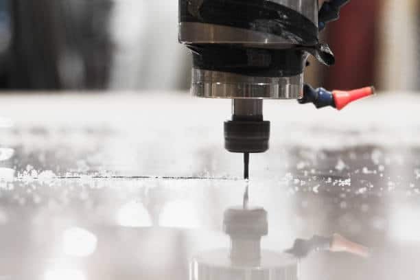 Close-up of CNC milling machine cutting a plastic sheet