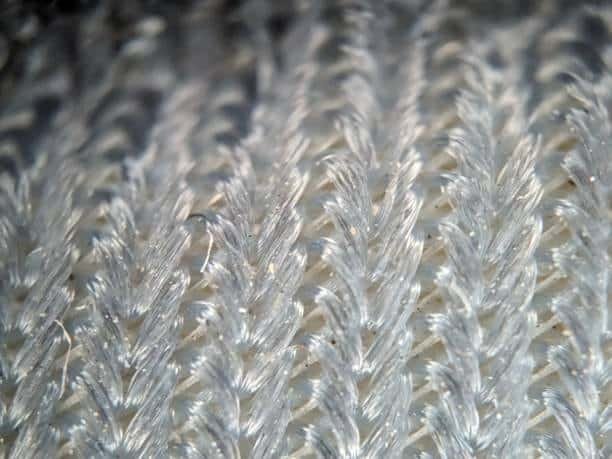 Close-up of molded plastic surface with knit line resembling stitched pattern