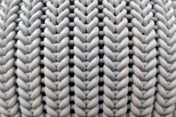 Molded plastic with knit-like texture representing weld line appearance