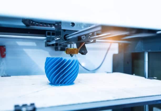Blue spiral component being formed in 3D printer