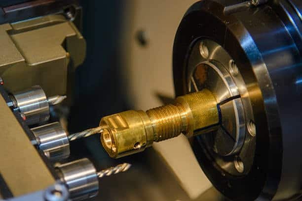 Swiss CNC machine machining a brass workpiece for high-precision application