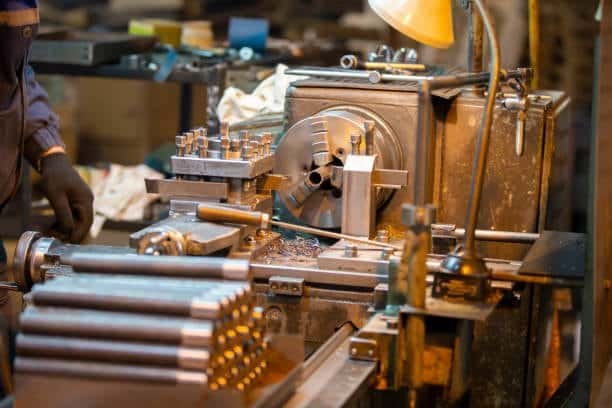 Traditional lathe operating with bar stock, often contrasted with Swiss CNC technology