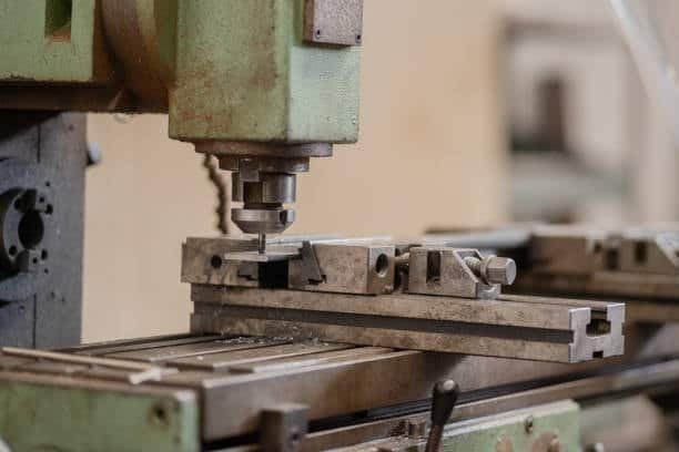 Manual vertical milling machine with part clamped in a workholding fixture
