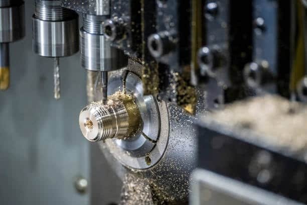 Close-up of CNC lathe machine cutting and shaping a metal component.